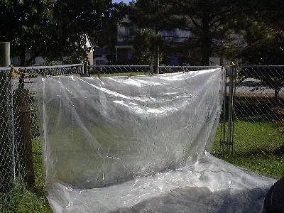 Plastic tarp
strung across corner of fence