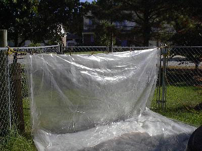Plastic tarp
strung across corner of fence
